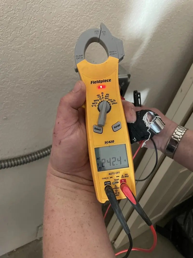 Voltage testing with clamp meter during Electrical Installation Services in Kuna